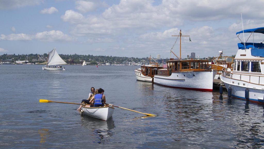 Rowboat and classic yacht on Lake Union