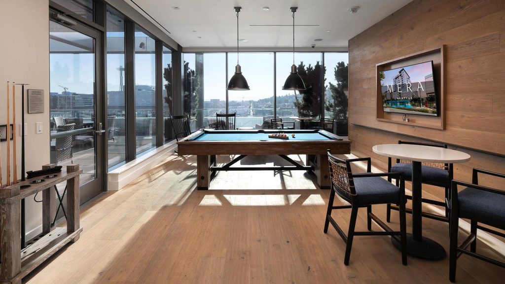 Rooftop clubhouse with pool table and city views