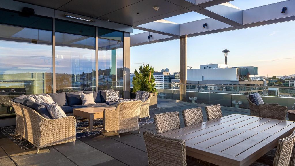 Outdoor conversation area and dining table with city view