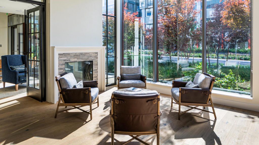 Lobby seating area with four chairs and fireplace