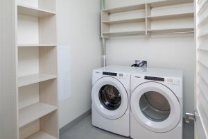 laundry area with washer, dryer and shelves